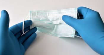 Customizable COVID-19 testing packages launched to help manage and treat virus mask-held-in-gloved-hands
